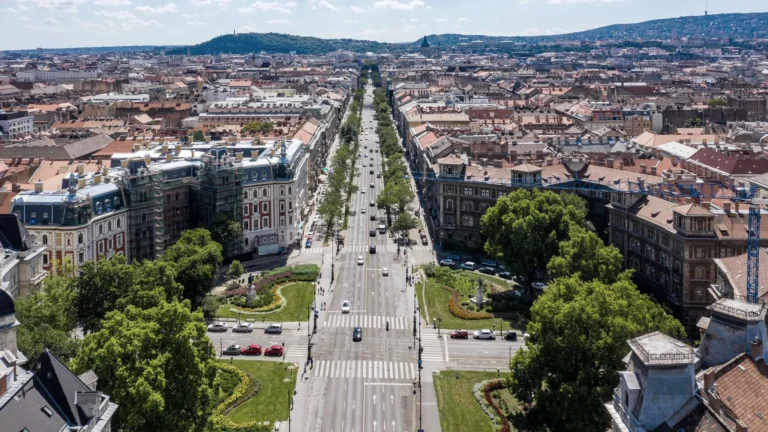 Aerial daytime view along Andrássy Avenue and the historic Pest cityscape in Budapest