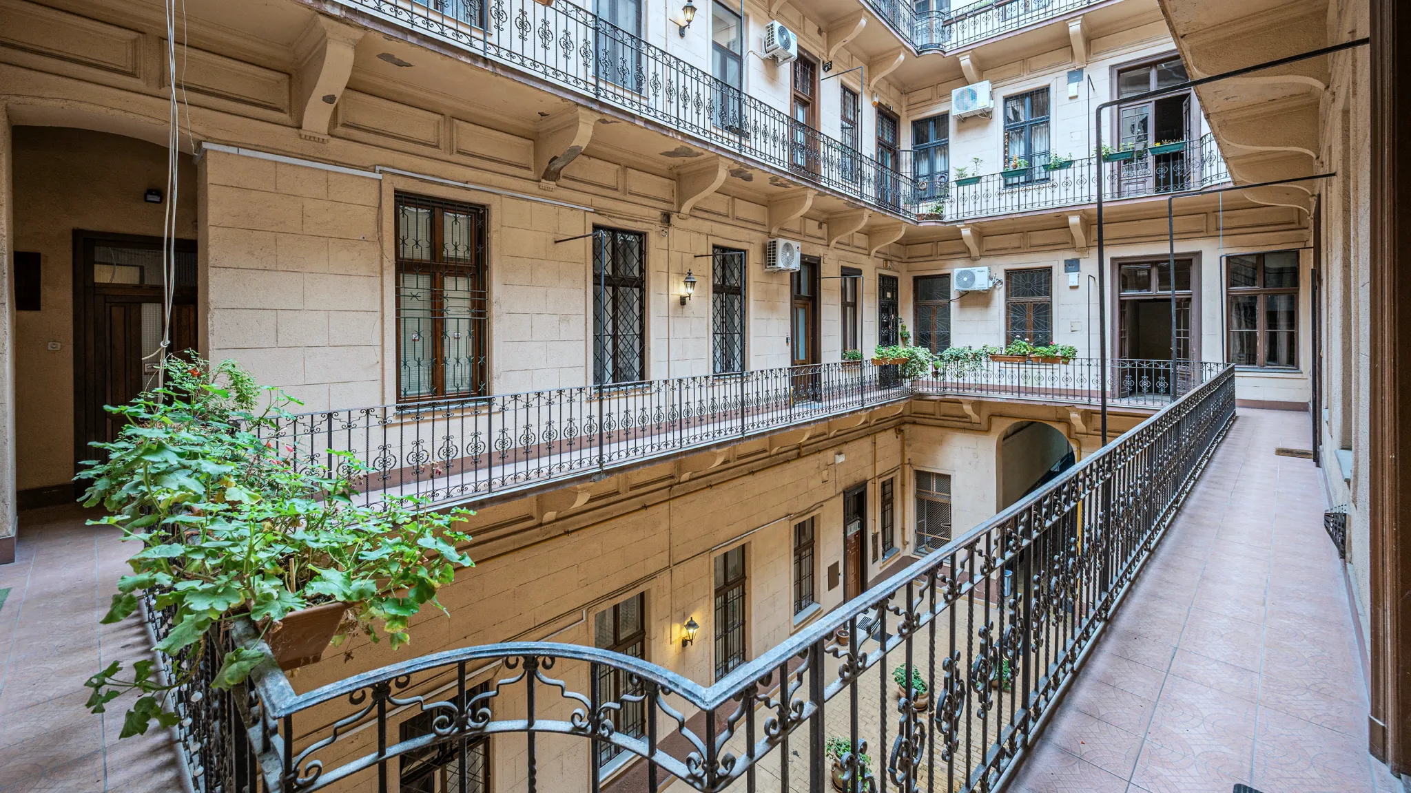 Historic Budapest condominium interior courtyard with open galleries and wrought-iron railings